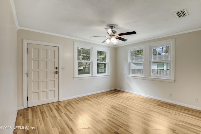 foyer entrance with light wood-type flooring, plenty of natural light, and ornamental molding