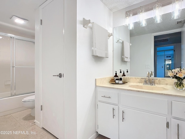 full bathroom with toilet, shower / bath combination with glass door, a textured ceiling, vanity, and tile patterned flooring