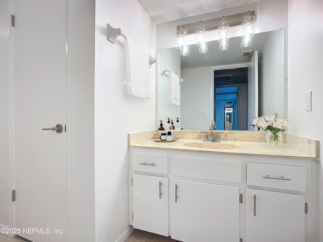 bathroom featuring vanity and a textured ceiling