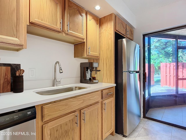 kitchen featuring appliances with stainless steel finishes, sink, and light tile patterned floors