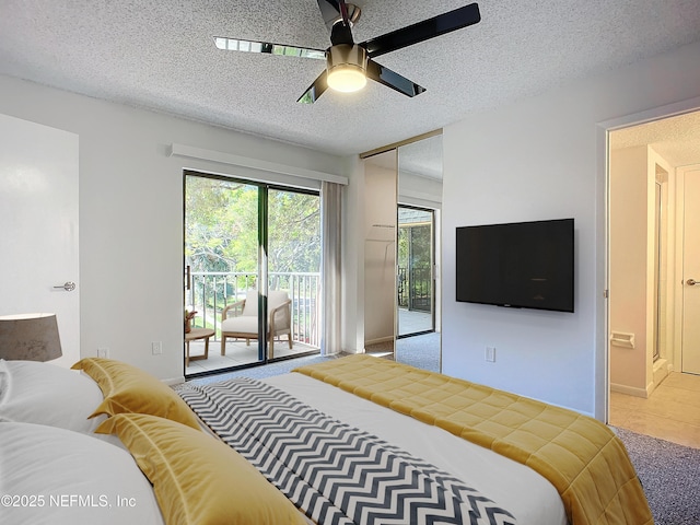 bedroom featuring ceiling fan, access to exterior, and a textured ceiling