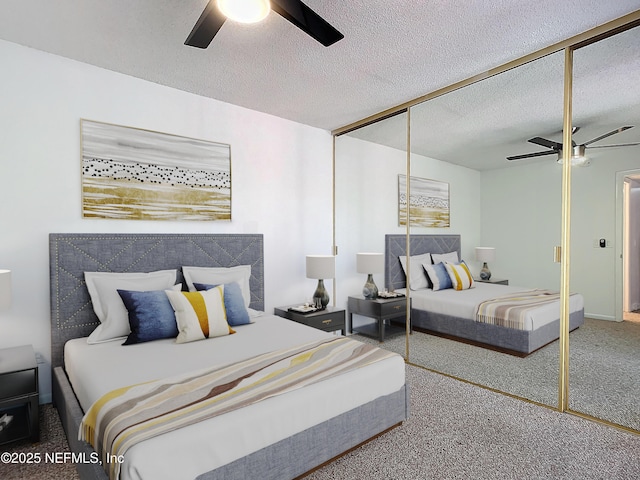 carpeted bedroom featuring ceiling fan, a closet, and a textured ceiling