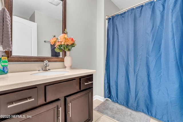 bathroom with tile patterned flooring, vanity, and curtained shower