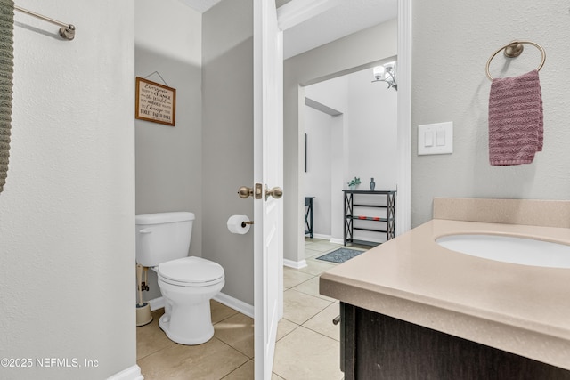 bathroom with tile patterned floors, toilet, and vanity