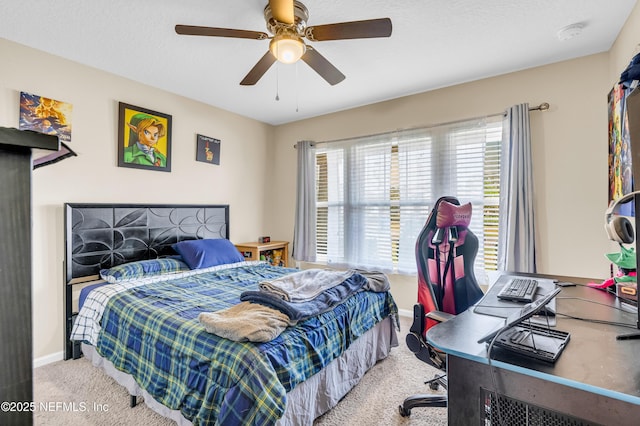 bedroom featuring light carpet, ceiling fan, and a textured ceiling