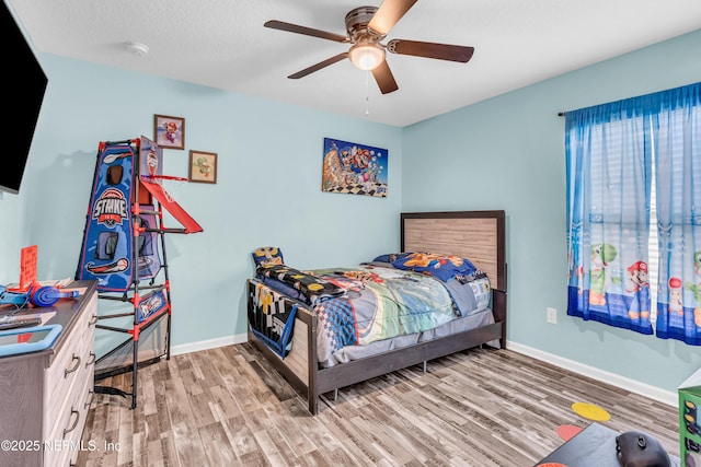 bedroom featuring a textured ceiling, ceiling fan, and light hardwood / wood-style flooring