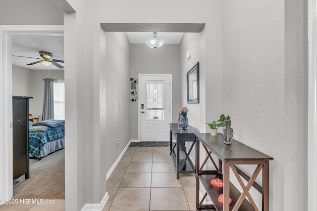 interior space with ceiling fan