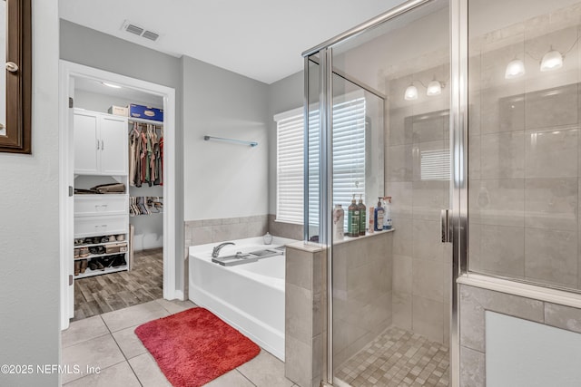 bathroom featuring tile patterned flooring and plus walk in shower