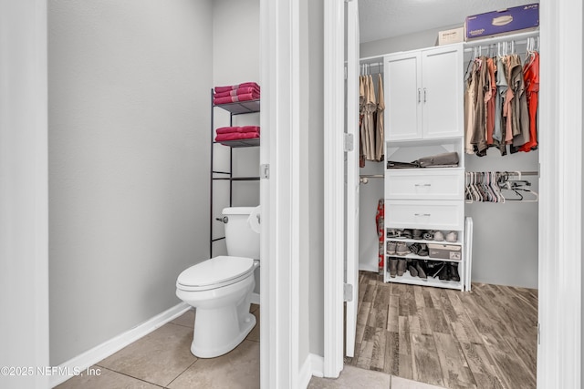 bathroom featuring tile patterned floors and toilet