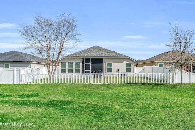 rear view of property with a yard