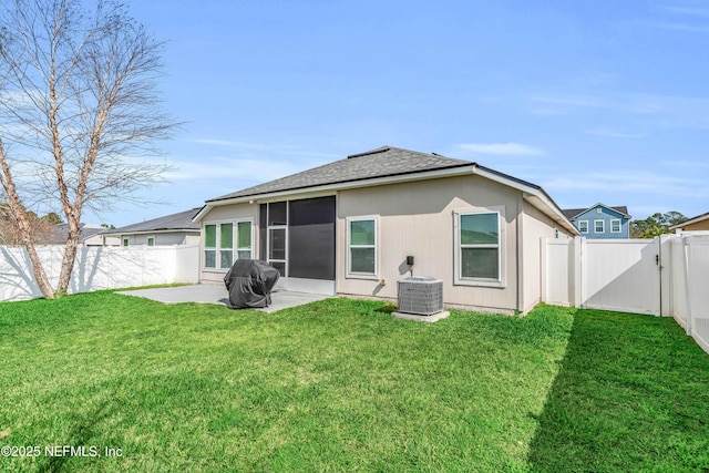 rear view of house featuring a yard, central AC, and a patio