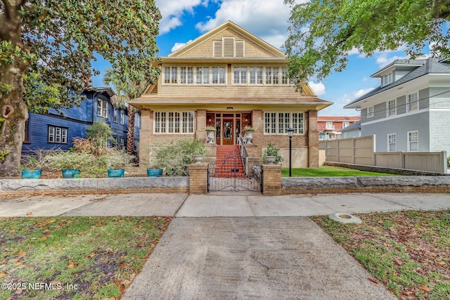 view of front of property featuring brick siding and fence