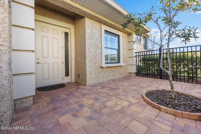 property entrance featuring a patio area