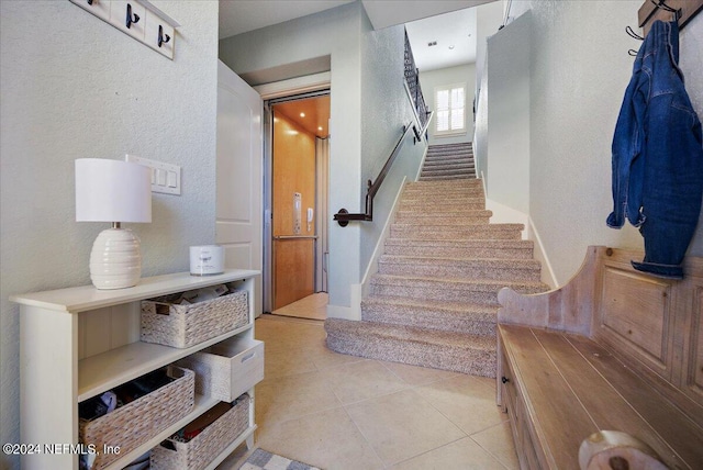 staircase with tile patterned floors