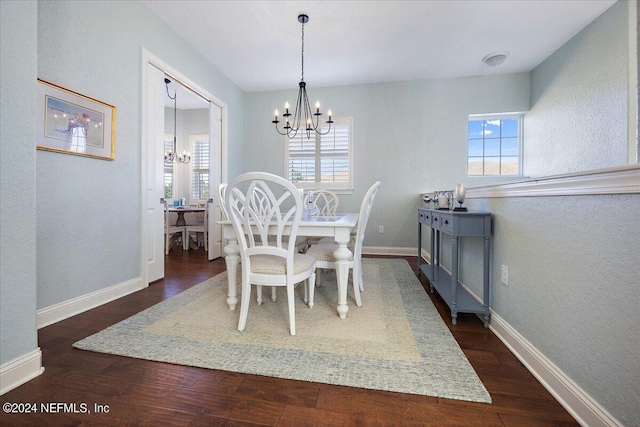 dining room with an inviting chandelier and dark hardwood / wood-style floors