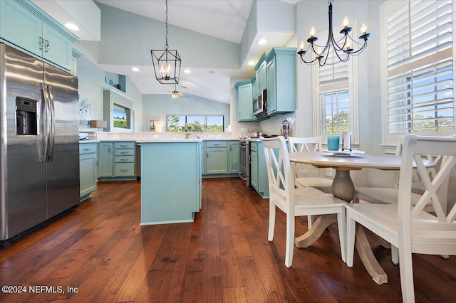 kitchen featuring hanging light fixtures, stainless steel appliances, blue cabinets, dark hardwood / wood-style flooring, and decorative backsplash