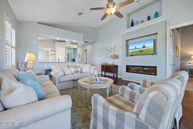 living room featuring ceiling fan, dark hardwood / wood-style floors, and high vaulted ceiling