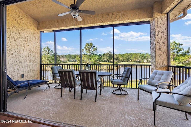 sunroom featuring plenty of natural light and ceiling fan