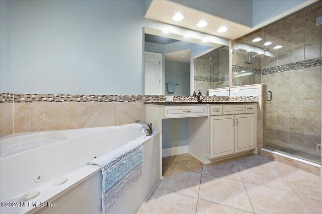 bathroom with tile patterned floors, vanity, and independent shower and bath