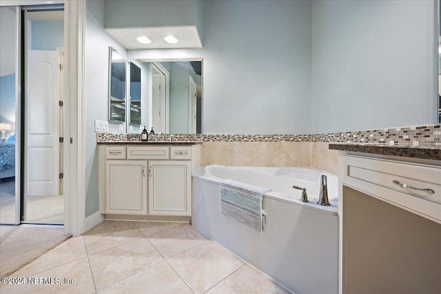 bathroom featuring tile patterned flooring, vanity, and a bathing tub