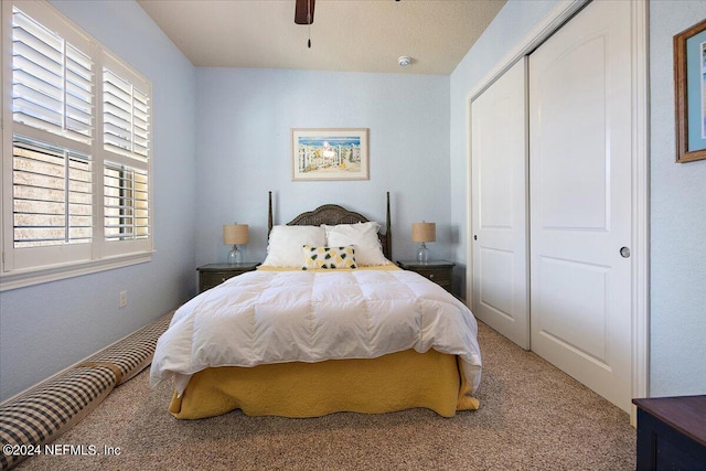 bedroom featuring a closet, ceiling fan, and carpet flooring