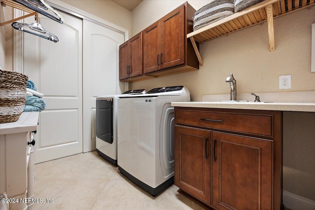 laundry room with cabinets, sink, light tile patterned floors, and independent washer and dryer