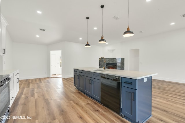 kitchen featuring white cabinetry, dishwasher, sink, and hanging light fixtures