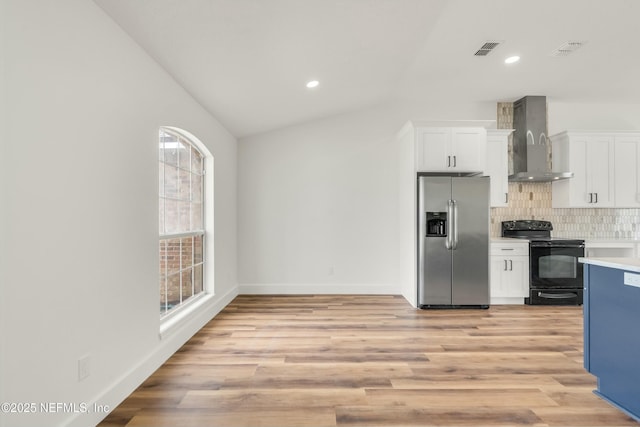 kitchen with stainless steel refrigerator with ice dispenser, wall chimney exhaust hood, white cabinetry, tasteful backsplash, and black / electric stove