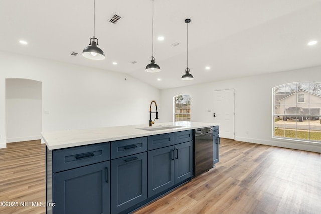 kitchen with dishwasher, sink, hanging light fixtures, and a center island with sink