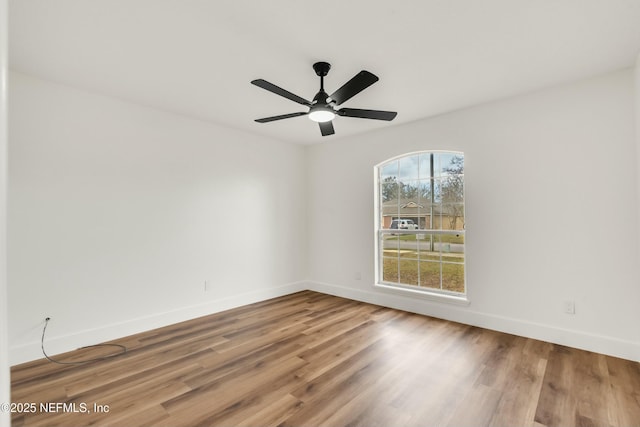 empty room featuring ceiling fan and hardwood / wood-style floors