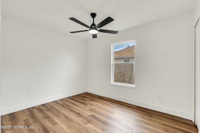 empty room featuring ceiling fan and light wood-type flooring