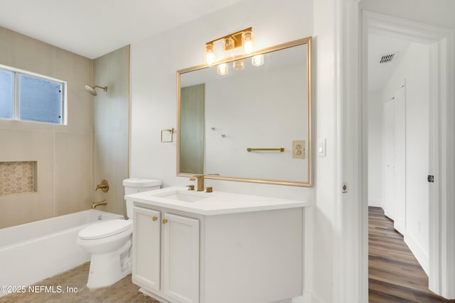 full bathroom with vanity, toilet, and tiled shower / bath