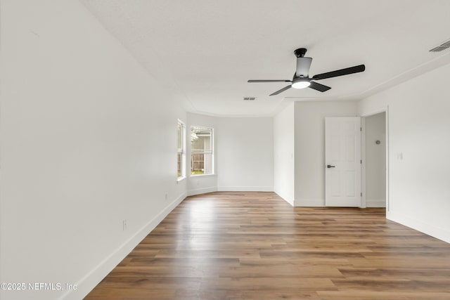 empty room with ceiling fan and wood-type flooring