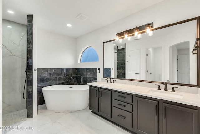 bathroom with independent shower and bath and vanity