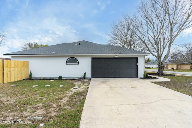 view of front of home with a garage and a front lawn