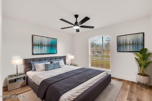 bedroom featuring light hardwood / wood-style flooring and ceiling fan