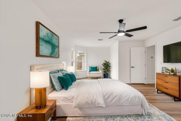 bedroom featuring light hardwood / wood-style flooring and ceiling fan