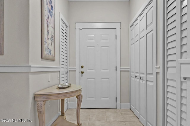 doorway with light tile patterned floors