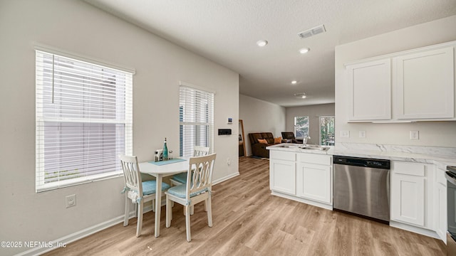 kitchen featuring a sink, light wood-type flooring, white cabinets, and stainless steel dishwasher