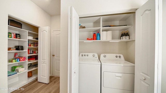 washroom with laundry area, light wood-type flooring, and washer and dryer