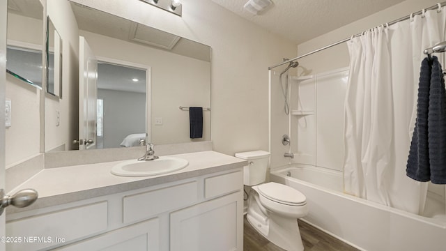 full bath with toilet, wood finished floors, shower / bath combo with shower curtain, a textured ceiling, and vanity