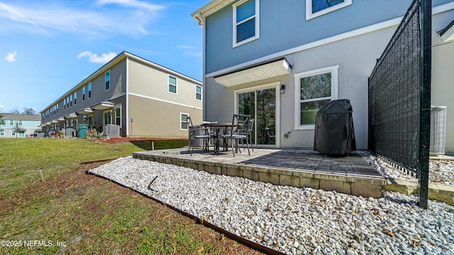 back of house featuring cooling unit, a patio area, and stucco siding