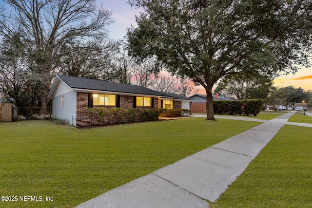 ranch-style house with a lawn