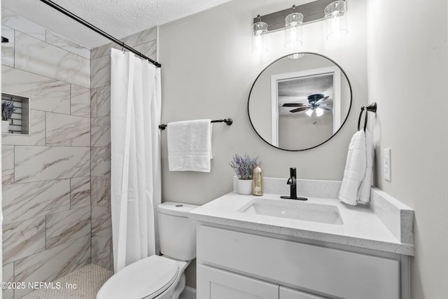 bathroom featuring vanity, toilet, curtained shower, and a textured ceiling