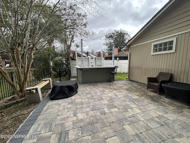 view of patio / terrace with a hot tub