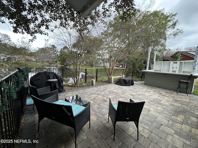 view of patio featuring area for grilling and a water view