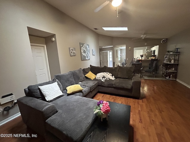 living room featuring vaulted ceiling, hardwood / wood-style floors, and ceiling fan