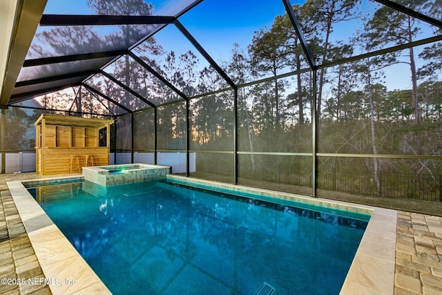 85158 Southern Creek Blvd, Fernandina Beach, FL 32034 - pool at dusk featuring an in ground hot tub, a patio, and a lanai