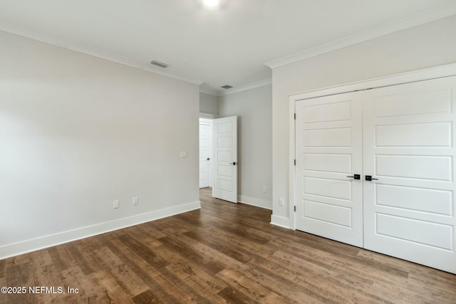 85158 Southern Creek Blvd, Fernandina Beach, FL 32034 - unfurnished bedroom featuring dark hardwood / wood-style flooring, ornamental molding, and a closet