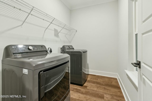 85158 Southern Creek Blvd, Fernandina Beach, FL 32034 - washroom featuring hardwood / wood-style flooring and washer and clothes dryer